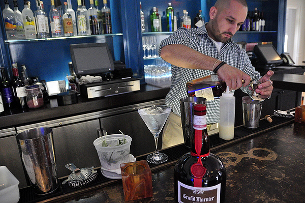 Danny Zuleta makes a Wilkinson's Horse behind the bar at Topping Rose House in Bridgehampton. MICHELLE TRAURING