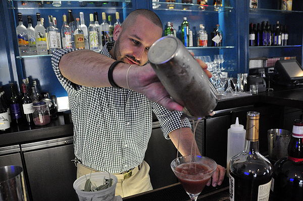 Danny Zuleta makes a Wilkinson's Horse behind the bar at Topping Rose House in Bridgehampton. MICHELLE TRAURING