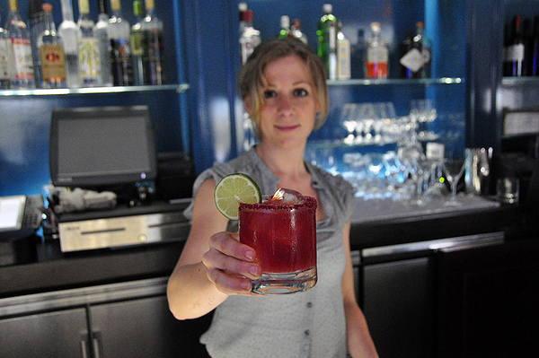 Jessica Koenig makes a Beetarita behind the bar at Topping Rose House in Bridgehampton. MICHELLE TRAURING