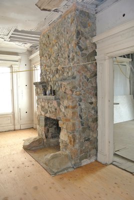 Stones from Gardiners Island make up a downstairs fireplace.  DANA SHAW