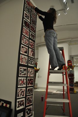 Kerrie Sundara helps install the 22nd annual Student Art Festival Part I at Guild Hall in East Hampton. MICHELLE TRAURING