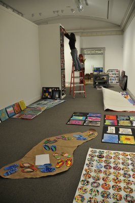 Kerrie Sundara helps install the 22nd annual Student Art Festival Part I at Guild Hall in East Hampton. MICHELLE TRAURING