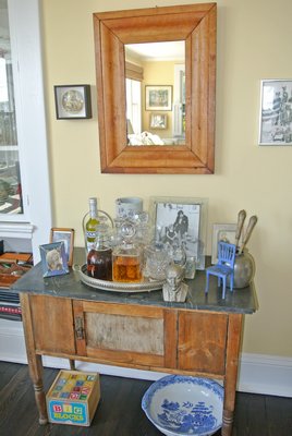 An English pine sideboard serves as a bar, some decanters more important than others.