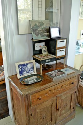 A 19th-century toy stove displays some photographs.