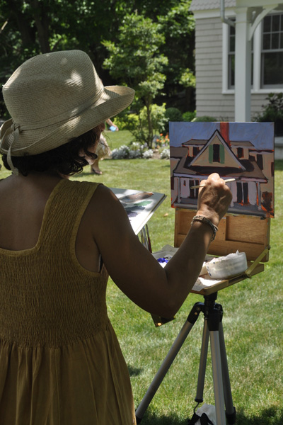Artist Carol C. Young paints outside "The Cottage" next to the McBride House on Woodbridge Lane on Quiogue. MICHELLE TRAURING