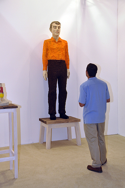 Matt Benham sizes up "Man with Orange Shirt" by Stephan Balkenhol. MICHELLE TRAURING