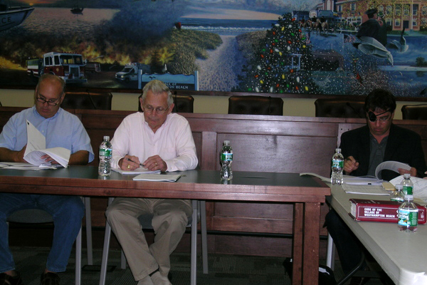 Board Member Jim Kametler, Mayor Conrad Teller and Board Member Hank Tucker look over a proposed interim agreement by Cablevision at the Wednesday, September 23, work session.