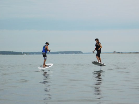 William Graham and Kieran McGuire, founders of Elevated East, riding their eFoil boards in North West Harbor on Monday morning.   ELIZABETH VESPE