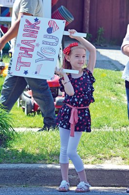 May 30: Emily Rose, 6, has a special message for veterans during the Hampton Bays Memorial Day parade.
