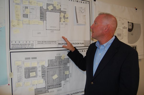 Superintendent Robert Hauser looks over the expansion blueprints. VALERIE GORDON