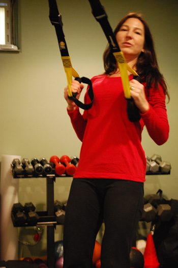 Personal trainer Donna Pierro demonstrating the gym in the basement of her Flanders home.<br>Photo by Will James