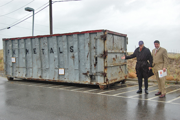 John Waffenschmidt and Steven Bossotti of Covanta Energy next to the dumpster that fishermen can unload their decrepit gear into at the Shinnecock dock.