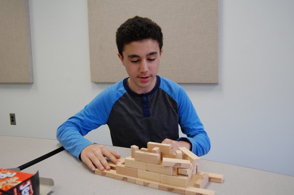 Aidan Ocsu building with Jenga blocks during the Pierson Middle/High School afterschool program. JON WINKLER