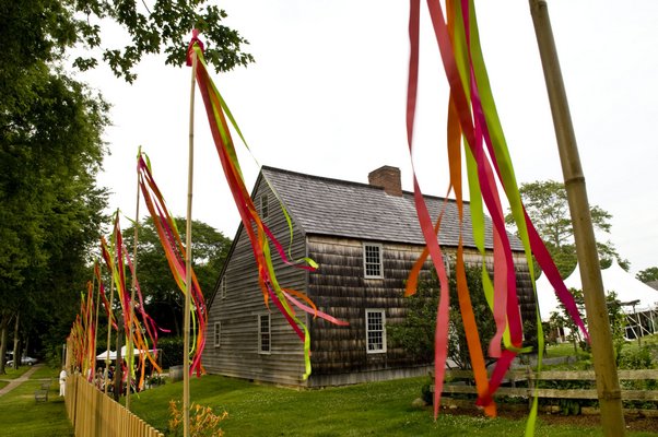 Guests will be greated at Mulford Farm from July 19-20 with brightly colored streamers marking the start of the 3.5-acre antique show. COURTESY EAST HAMPTON HISTORICAL SOCIETY