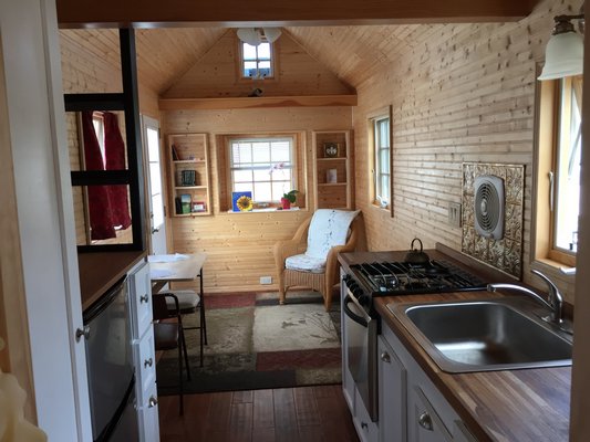 The living room and dining room have a built-in, three-person table and a day bed. COURTESY DEBRA PETERS