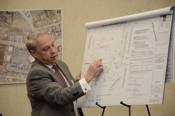 James Havrilla, an architect with H2M in Melville, shows plans of where additional entrances and exits to a 60-unit apartment complex could be located. GREG WEHNER