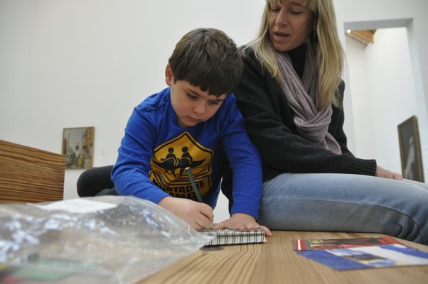 J.P. Carrello draws while his mother, Adrian, looks on. MICHELLE TRAURING