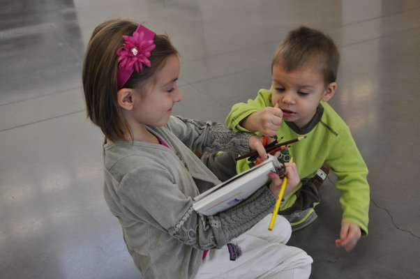 Adriana and Marc-Andre Tapfer fight over colored pencils. MICHELLE TRAURING