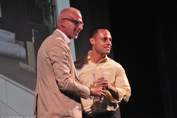 Jamie Drake, left, presents a representative from Stelle Lomont Rouhani Architects with the award for Innovation in Bath Design. MICHELLE TRAURING