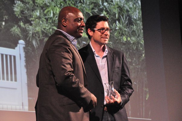 Dennis Howard, left, presents Zachary Crawford of Landscape Details with the runner-up prize for Innovation in Garden Design. MICHELLE TRAURING