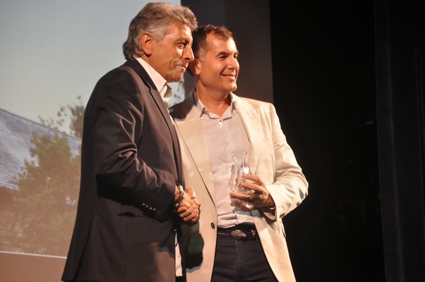 John Taranto, left, presents Russell Riccardi of Russell Riccardi Architects the runner-up prize for Innovation in Architecture Design. MICHELLE TRAURING