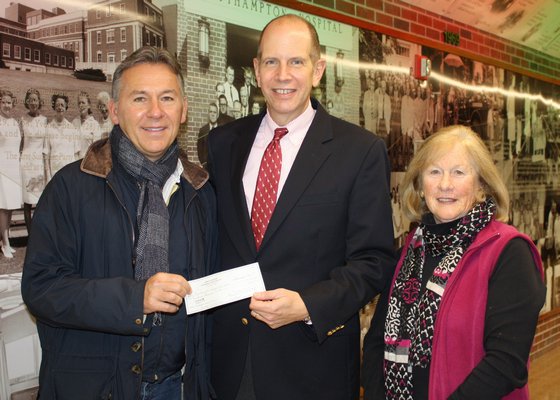 Representatives from the Hampton Designer Showhouse Foundation—Brian Brady, Board Member (left) and Mary Lynch, Operations Manager (right)—present a check for $100,000 to Robert S. Chaloner, Southampton Hospital President & CEO, from funds raised during the 2015 Hampton Designer Showhouse.