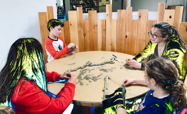 Hayground School Students assemble can tabs for  "Aeon," an art installation created over the course of the school year with artist-in-residence Alice Hope. ALICE HOPE