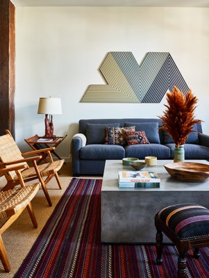 In this 1880s converted loft, note the richly layered history of the mid-century side table, recently reupholstered antique footstool with vintage kilim upholstery to complement the kilim pillows on the sofa, and the vessels on the coffee table from unknown periods. CHRISTIAN HARDER