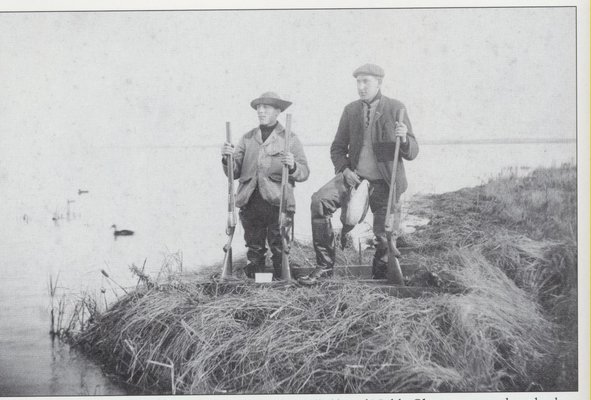Hunting on Shinnecock Bay, with one brant already in hand, circa 1908. HAMPTON BAYS HISTORICAL SOCIETY