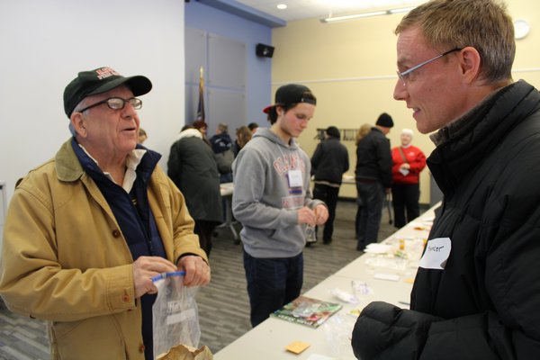 Peter Zendt, left, who learned about the event from the Peconic Land Trust, discusses the seeds at hand with computer programmer Spencer Robertus. Both were first-time seed swap attendees. 
