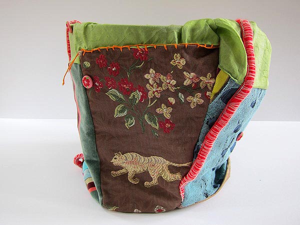 Embroidered patchwork and embellished bag, with a terra cotta pot inside, by Jill Musnicki. COURTESY ALEXANDRA EAMES