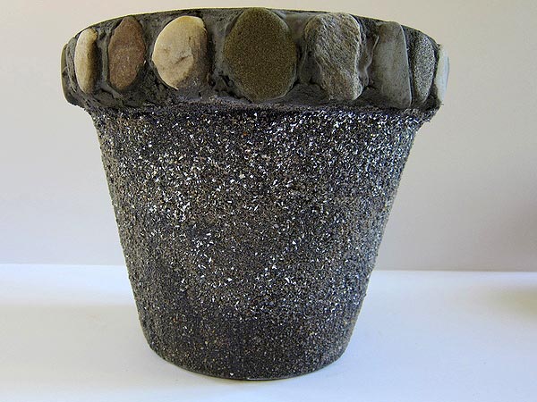 Painted and sand-covered terra cotta pot with glitter and beach stones on the rim by Jocelyn Worrall. COURTESY ALEXANDRA EAMES