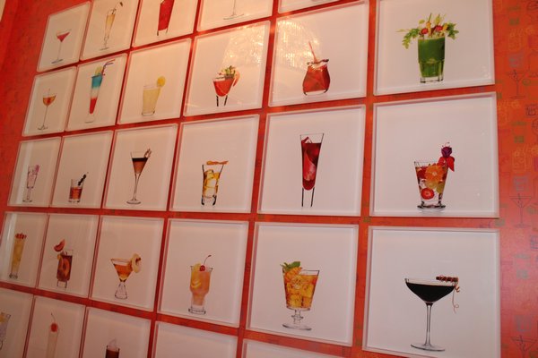 The bar features a wall of photos taken from designer Mark Addison's recent book, "Cocktail Chameleon."  JULIA HALSEY