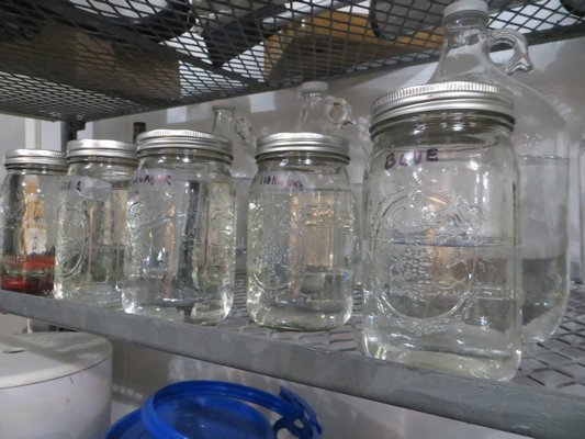 Mason jars are filled with alcohol at the distillery. ALEXANDRA TALTY