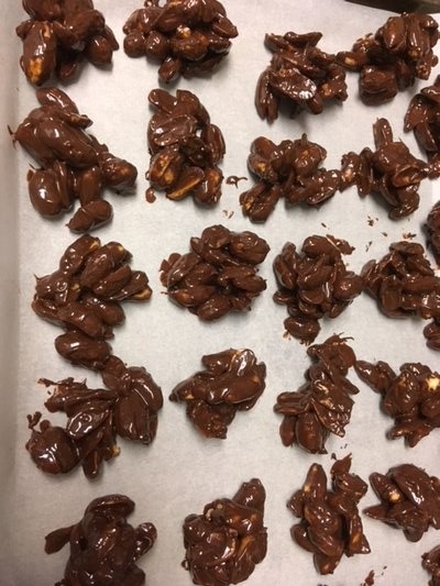Dark chocolate covered roasted Virginia Peanuts. (Just coated and packed into tin.)  JANEEN SARLIN