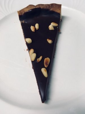 A slice of decadent dark chocolate tart BY JANEEN SARLIN