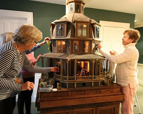 Ayse Kenmore, Joan Denny, Jean Rickenbach and Lynn Cotter (at right) decorate the dollhouse at the East Hampton LVIS headquarters. KYRIL BROMLEY