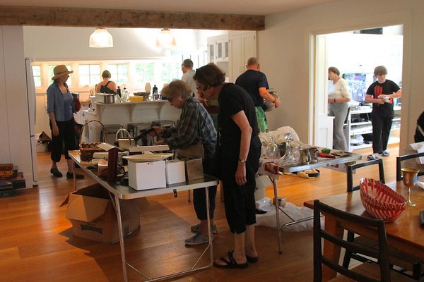 Shoppers browse through dozens of home and kitchen items at a White Goose estate sale in Amagansett. KYRIL BROMLEY