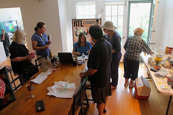 Shoppers browse through dozens of home and kitchen items at a White Goose estate sale in Amagansett. KYRIL BROMLEY