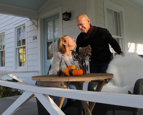 The Greenfields on their front porch in Amagansett. KYRIL BROMLEY