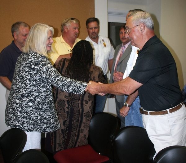 Southampton Village Trustee Nancy McGann shakes hands with Fire Commissioner Fred Andrews.