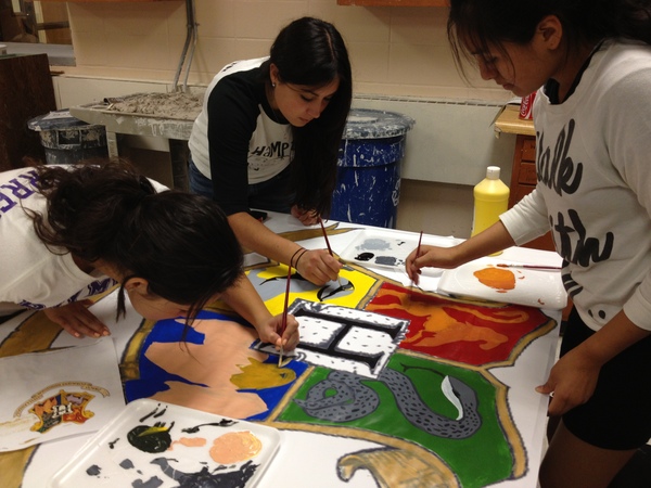 Seniors Daniela Gutierrez, Stephanie Salomon and Brenda Soto help paint decorations for the float.  JENNIFER LINARES