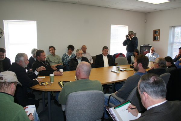 U.S. Representative Tim Bishop, second from left,  listens to concerns from farmers at the  Long Island Farm Bureau on Saturday. Headquarters In Calverton.