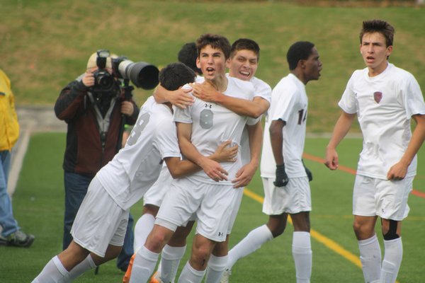 November 12 -- Nick West is swarmed by his teammates after scoring the tying goal before the East Hampton High School Soccer Team's Class A Championship win.