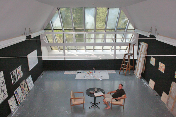 Painter Richmond Burton sits in the large studio at his home in North West Woods where Elaine deKooning and John Chamberlain once worked. <br>Photo by Oliver Peterson