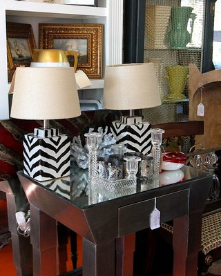 Statement piece: a silver Deco side table with tapered legs, beveled mirror top and drawer. On consignment from an antique shop, it's priced at $95.