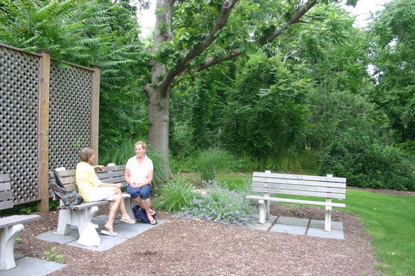 Hampton Bays visitors and residents enjoy the pocket park near Main Street that will be the entrance to Good Ground Park after the renovations to it are complete. KYLE CAMPBELL