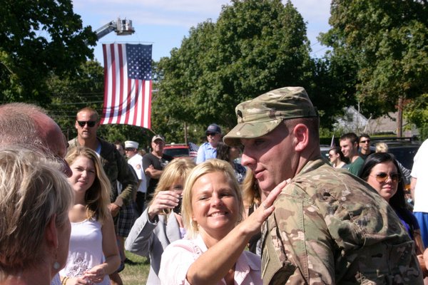 September 26: Army Specialist Andrew Kuroski enjoys plenty of hugs and smiles after returning to his hometown of East Quogue on Saturday following a nine-month deployment to Afghanistan.