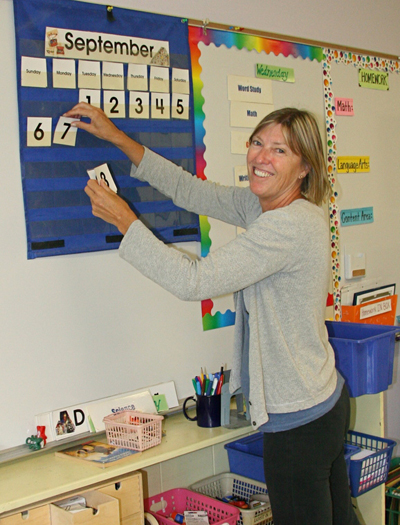 Tracey Frazier, a fifth grade teacher at the Springs School, prepares her classroom for students.