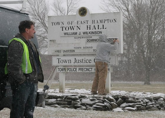 Jaunary 8 --  Out with the old and in with the new as a town workers install the names of the newly elected town council members on the sign outside East Hampton Town Hall.
